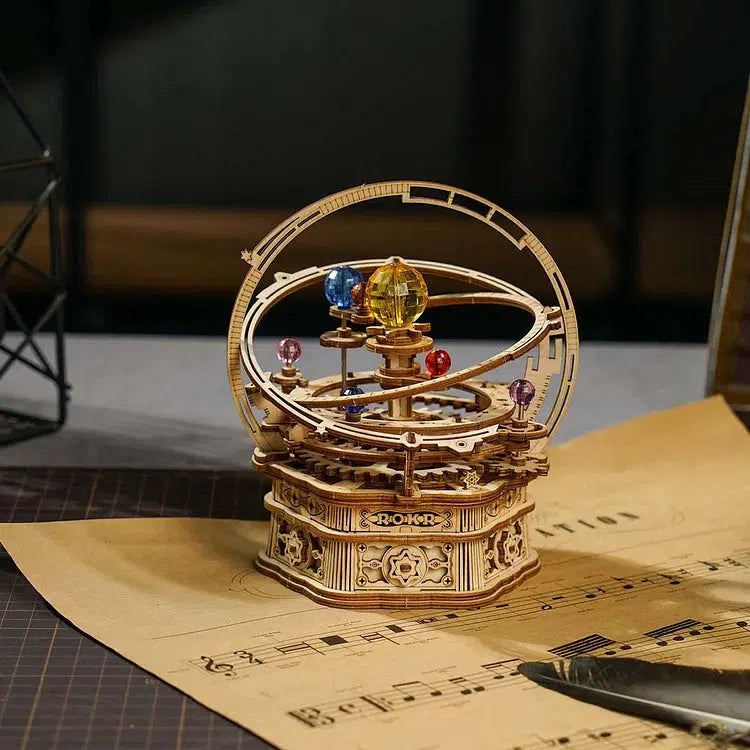 Starry night DIY wooden music box. Resembles planets circling the sun in the solar system.