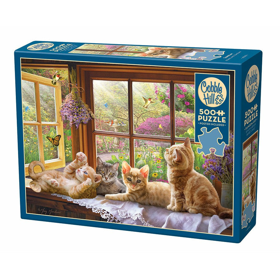 A 500-piece puzzle box featuring an image of four kittens lounging on a windowsill with a garden view in the background.