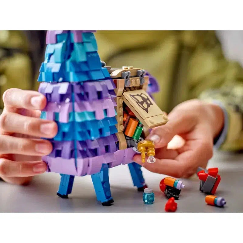 a kids hands opening the llama saddle from the side and dumping out the contents