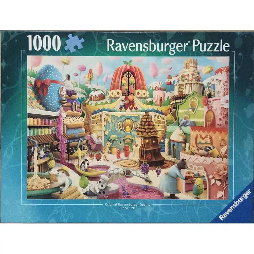 Colorful jigsaw puzzle box showing a whimsical village scene with anthropomorphic animals, giant sweets, and fantasy buildings. It has 1000 pieces and is made by Ravensburger.