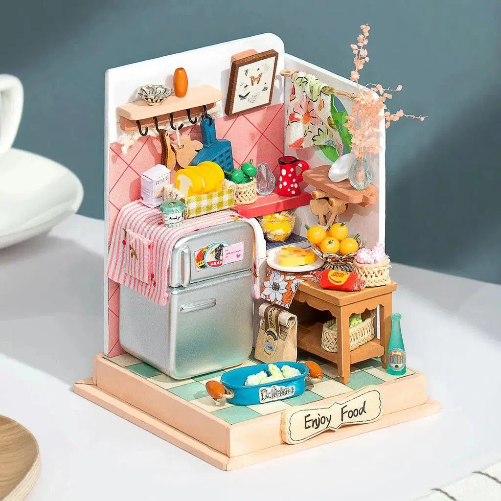 Small model of a kitchen with food all over and bright colors