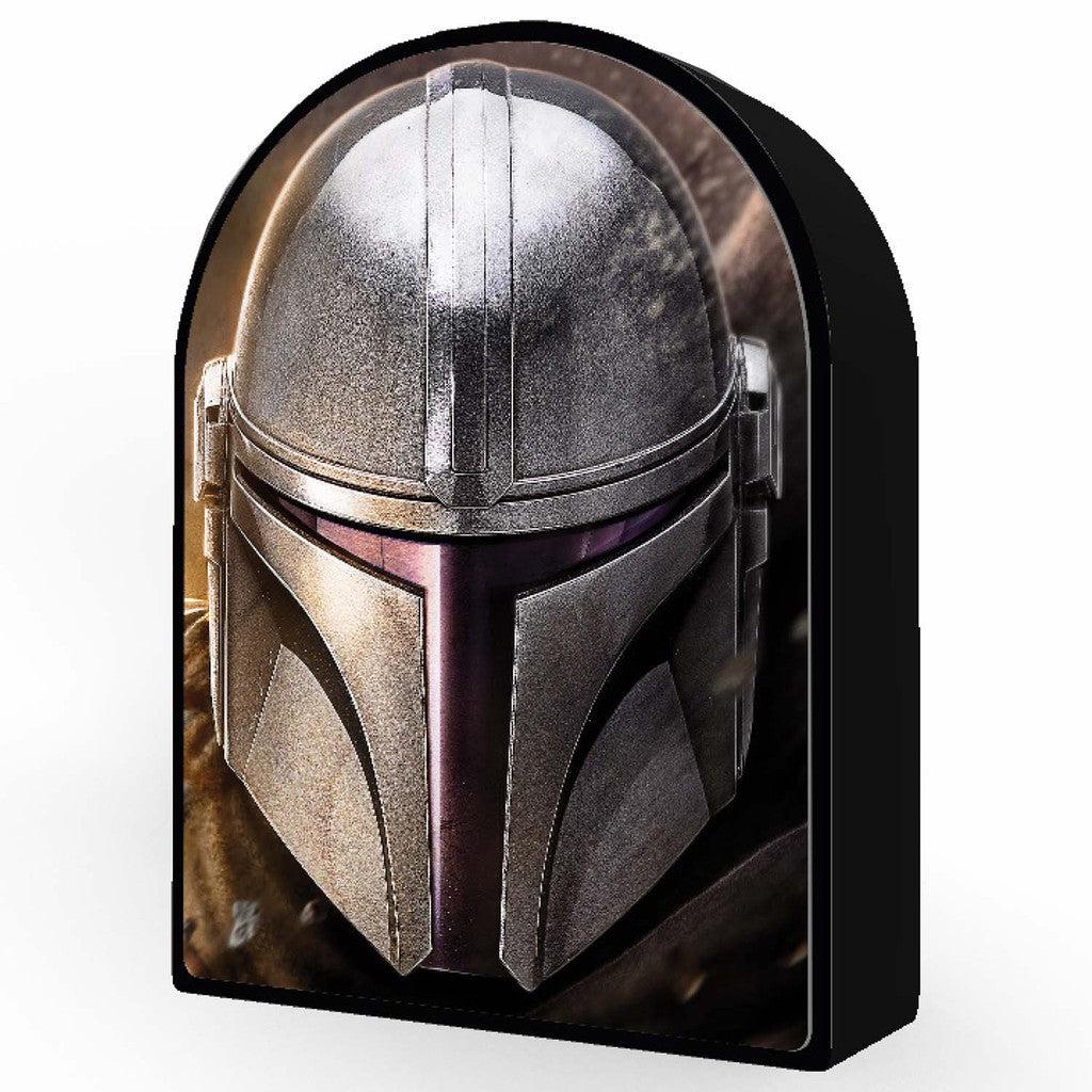 A helmeted figure in silver armor, reminiscent of The Mandalorian, stands out against a dark background. The iconic T-shaped visor adds intrigue to this striking image