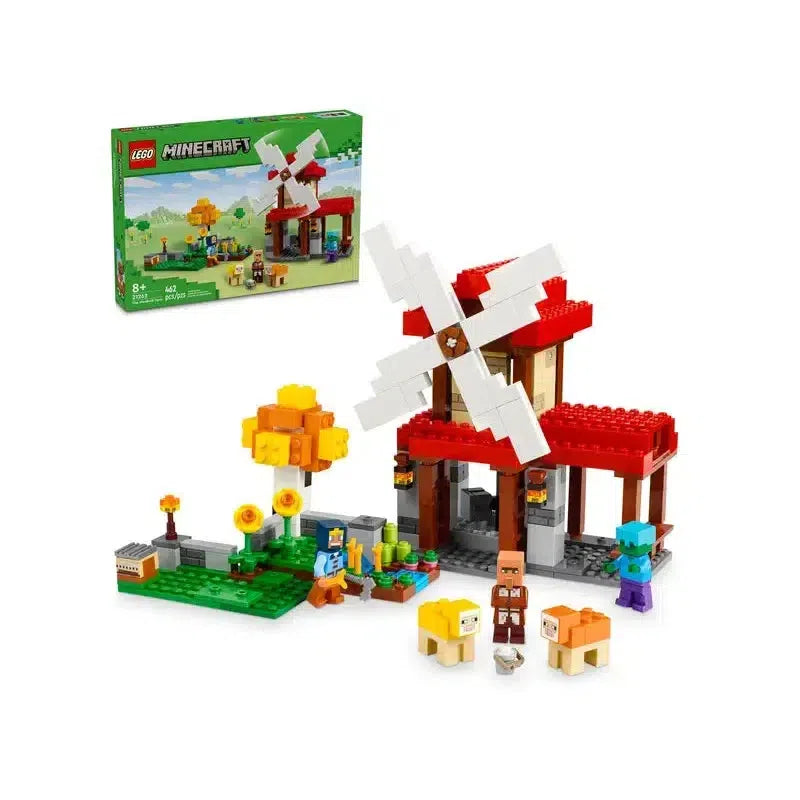 The lego set is shown in front of its box. There is a lego windmill with lego minecraft characters in front of it.