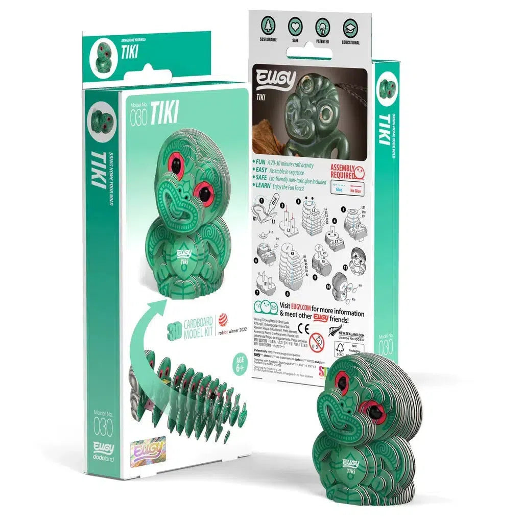 This eco-friendly cardboard model kit of a Tiki figure features vibrant green designs. The packaging includes assembly instructions and components, making it an engaging 3D puzzle that subtly incorporates STEM concepts for an enriching hands-on experience.