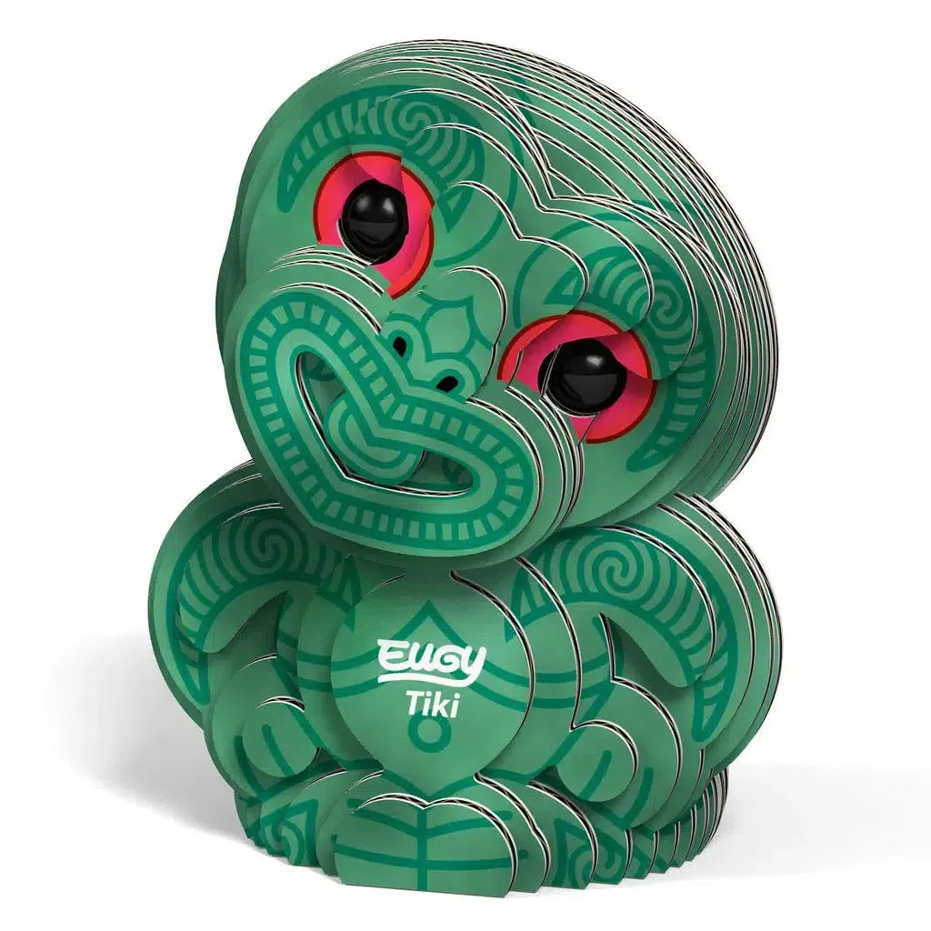 This eco-friendly, green and red patterned Tiki figure features a layered cardboard design, labeled EUGY Tiki. As a captivating 3D puzzle, it offers both creativity and sustainability in one charming package.