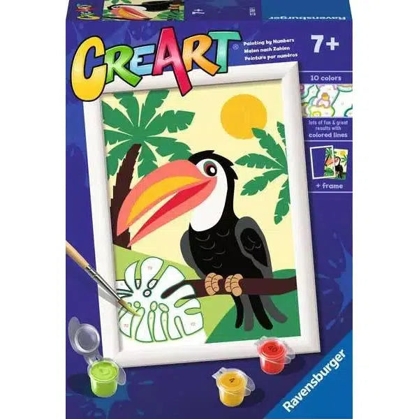 Explore the CreArt paint-by-numbers kit for ages 7+, featuring a vibrant toucan perched on a branch with tropical leaves and a sunlit background. This Ravensburger Online Store exclusive includes 10 colors and a brush, ensuring endless hours of creative fun.