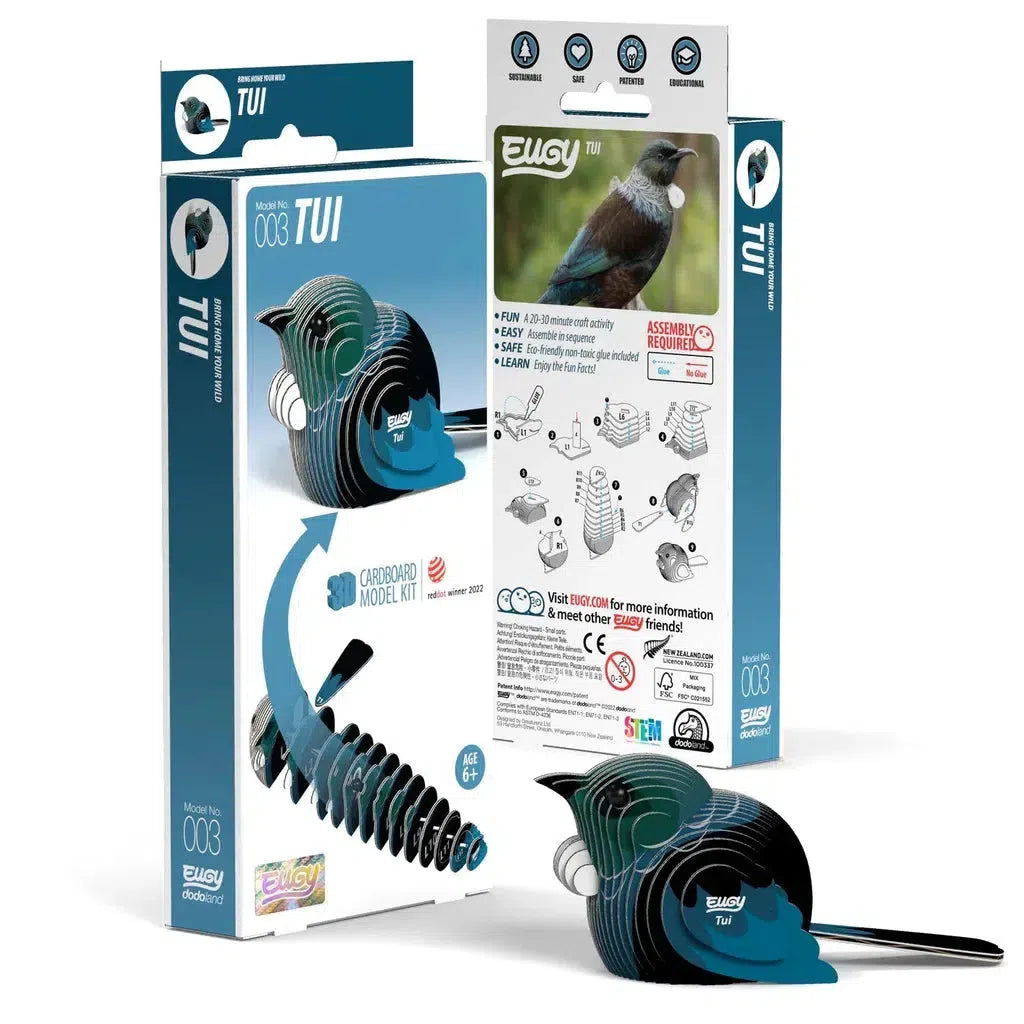 A cardboard model kit of a Tui bird, designed as an eco-friendly 3D puzzle, displayed with its packaging. The box shows assembly instructions and illustrations. The model features layered, curved shapes, encouraging exploration of STEM concepts through hands-on learning.