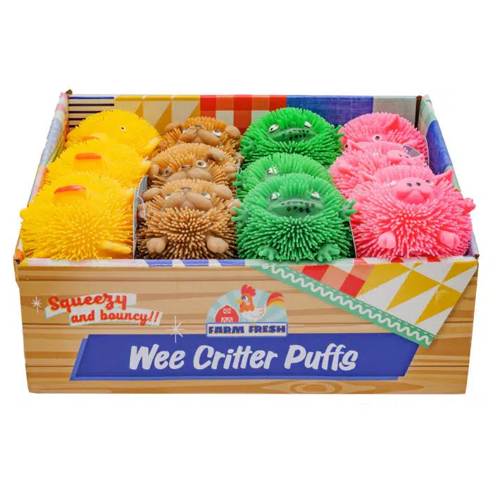 A box filled with colorful, stretchy rubber animal-shaped toys, labeled "Wee Critter Puffs." The spiky toys are yellow, brown, green, and pink, arranged neatly in rows.