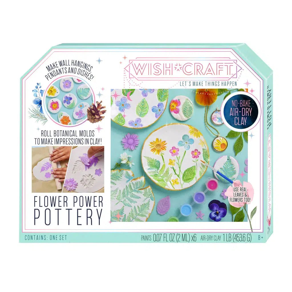 The Flower Power Pottery kit box showcases colorful clay plates with floral impressions, complete with paints, tools, and botanical stamps for creating stunning no-bake air-dry clay crafts.