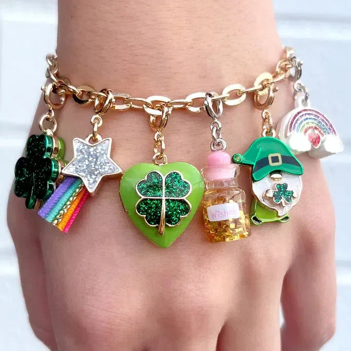 Gold charm bracelet featuring a four-leaf clover, star with rainbow, heart with clover, leprechaun, and a rainbow with clouds. Customize her collection with this dazzling piece adorned by a special bottle of wishes charm, elegantly worn on her hand.