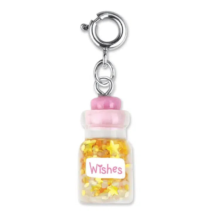 A small keychain with a clear jar resembling a bottle of wishes charm, filled with yellow star-shaped confetti. The jar, topped with a pink lid and adorned with a "Wishes" label, is the perfect addition to customize her collection or even attach to her favorite bracelet.