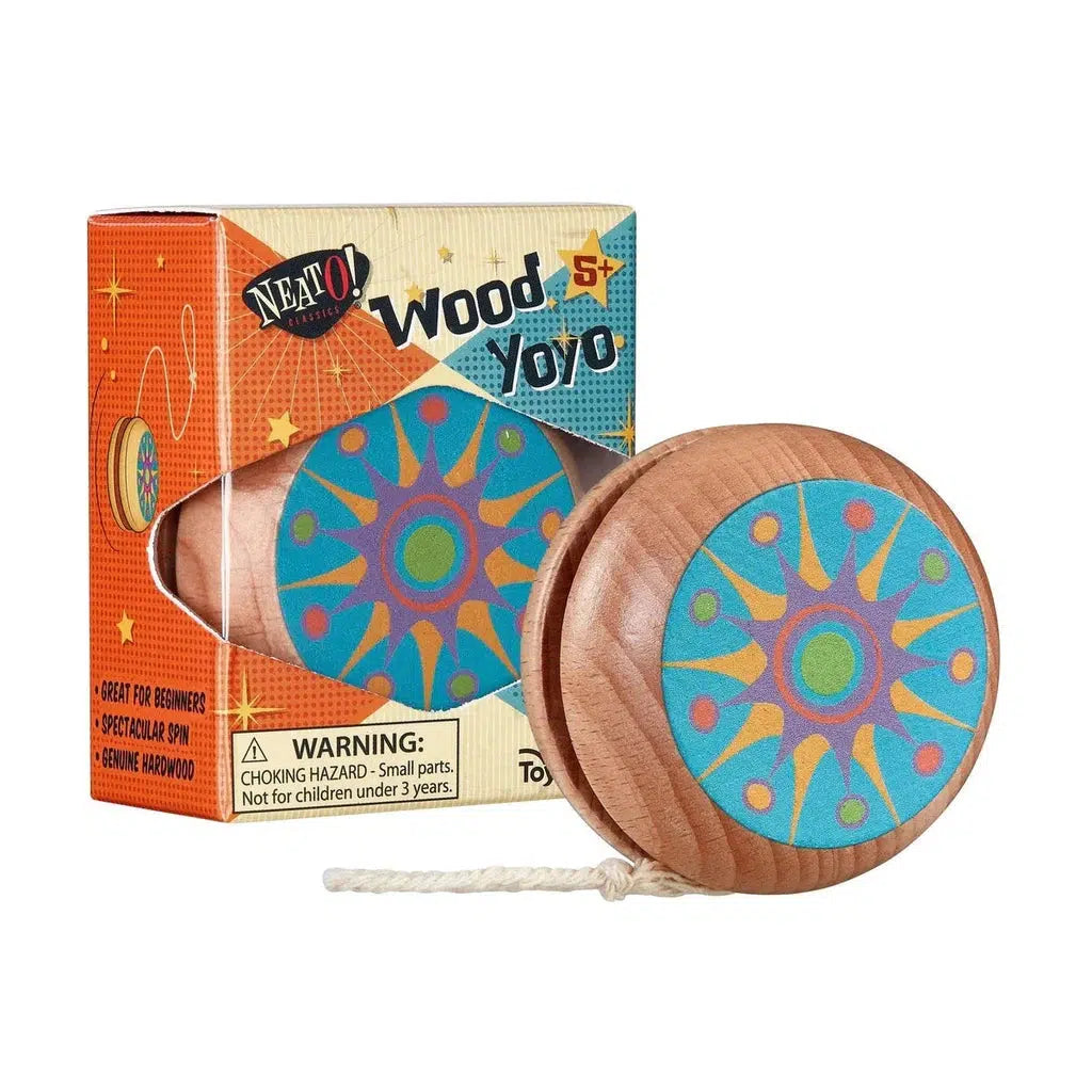 A wooden yo-yo crafted from beech wood features a vibrant star pattern and sits beside its packaging, labeled "Neato! Presents: Wood YoYo." Includes a warning about small parts.